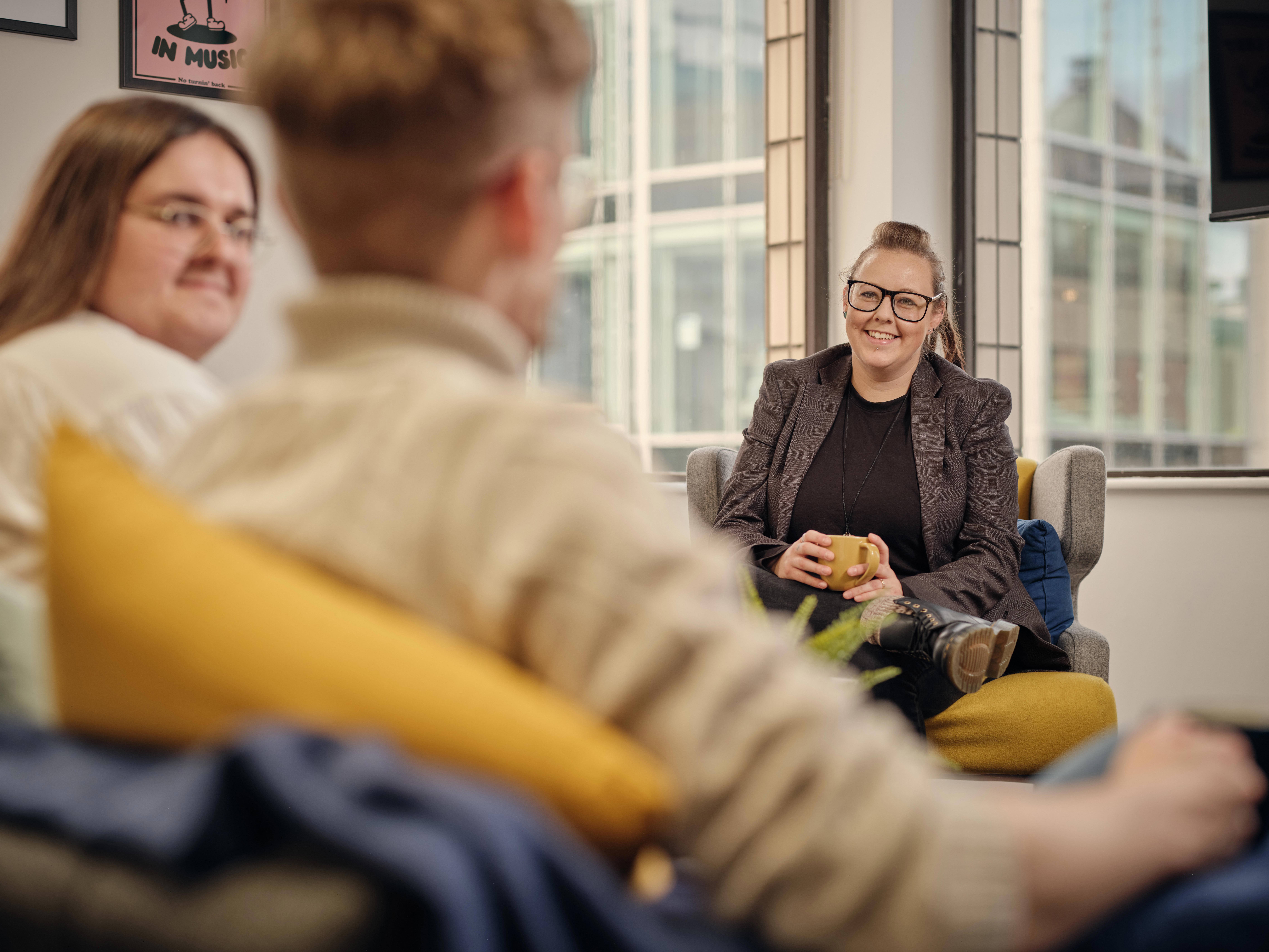 Group of Cantarus staff meeting in office lounge area