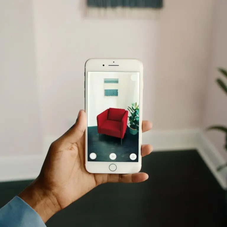 phone being used to view an armchair in augmented reality