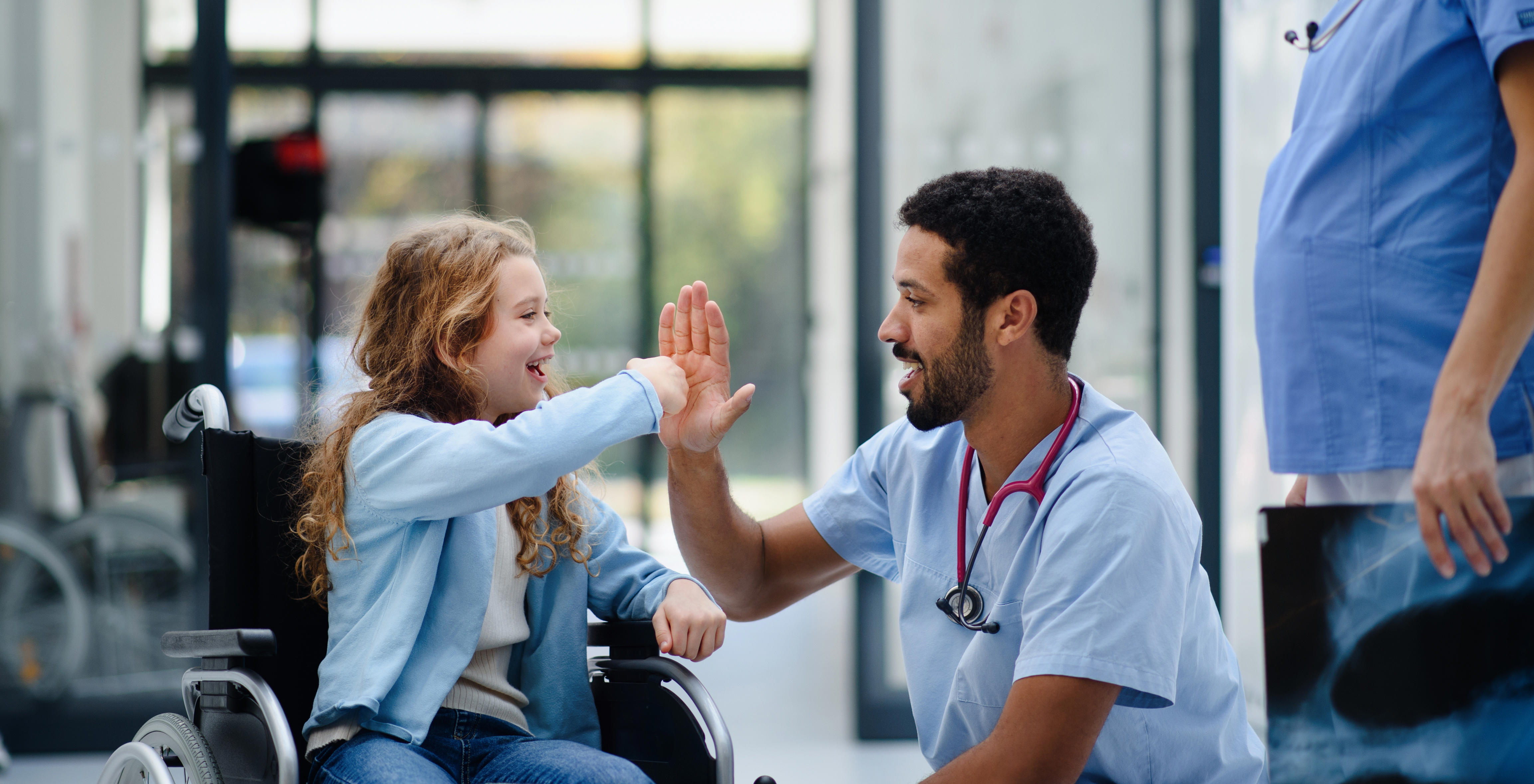 Young girl high fiving nurse