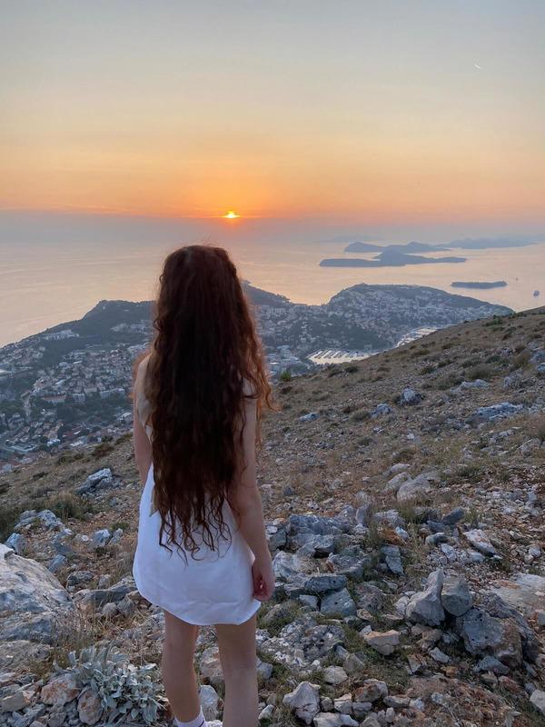 Alex looking at sunset on a mountain