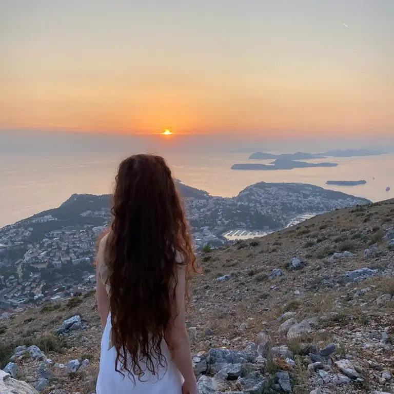 Alex looking at sunset on a mountain