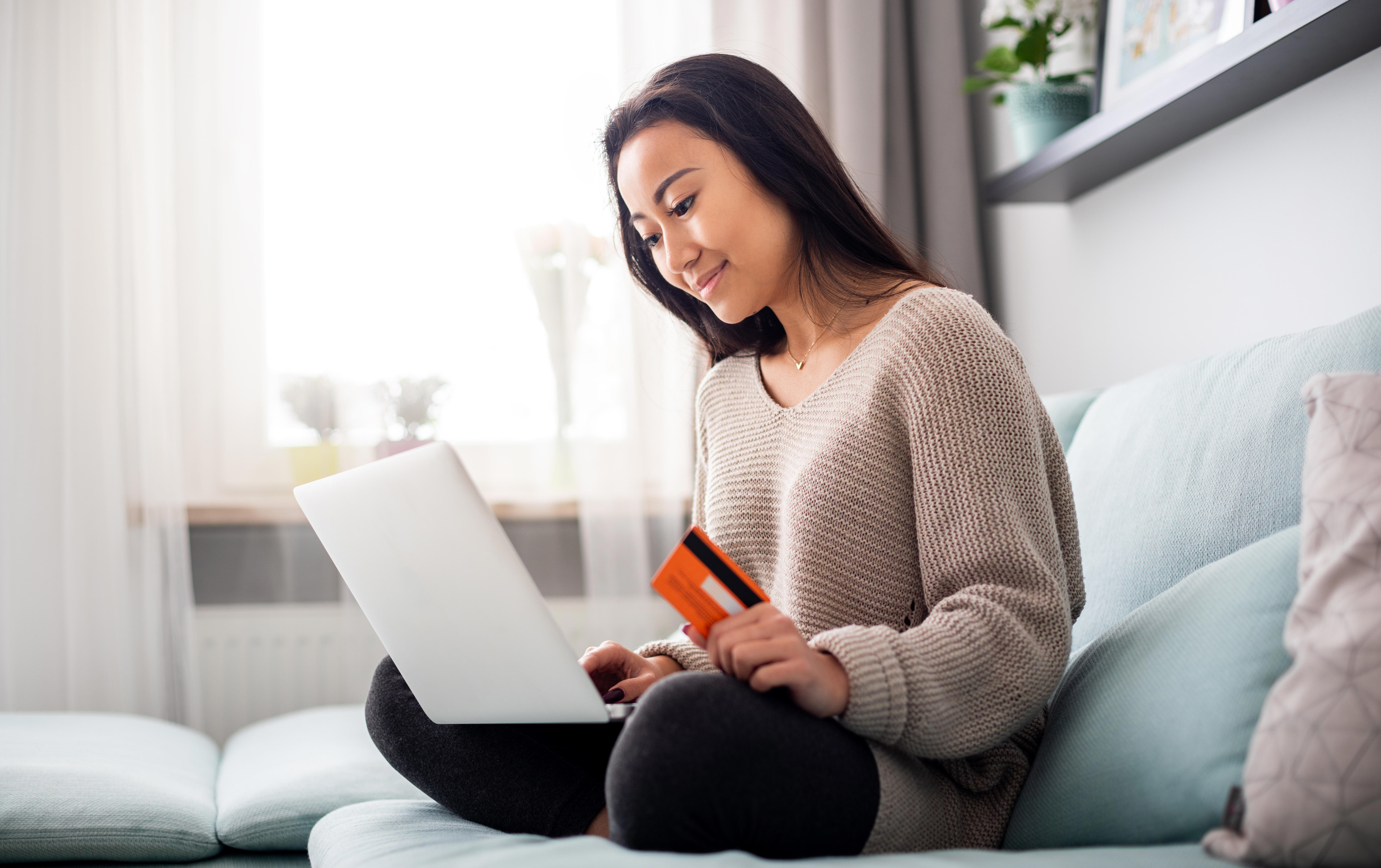 person sitting on sofa with laptop