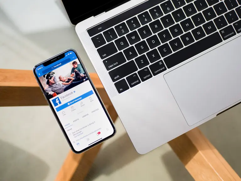 smartphone next to laptop keyboard