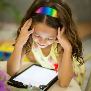 young child using a tablet