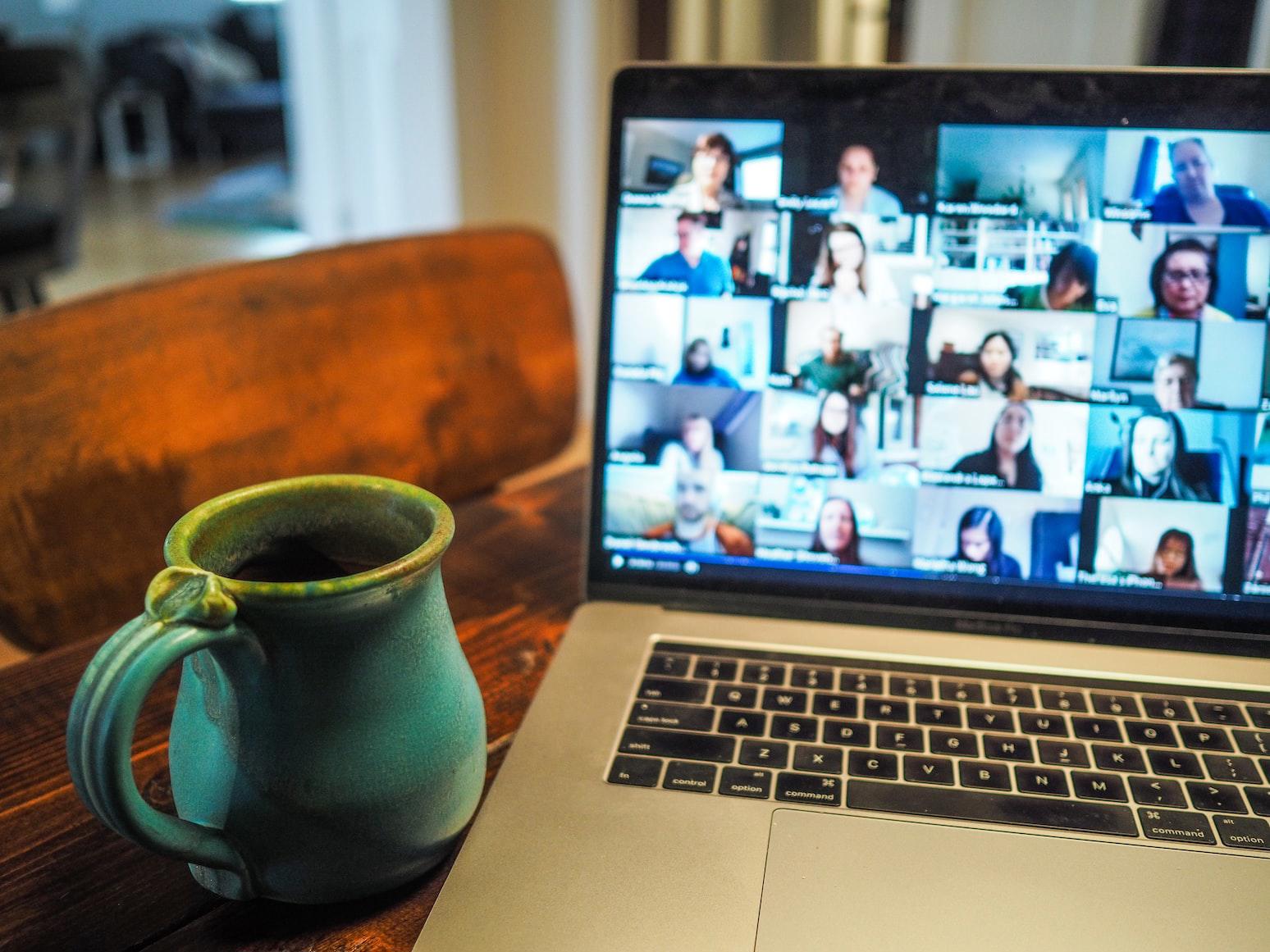 mug next to laptop video call screen