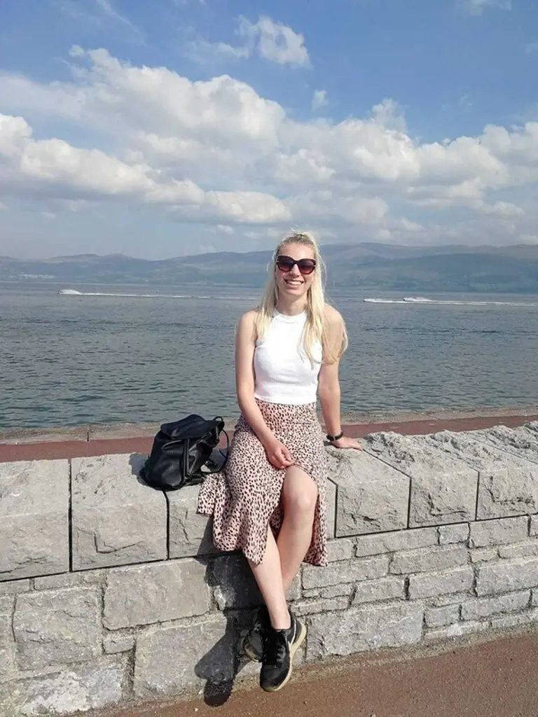 Jenny sat on wall by the sea