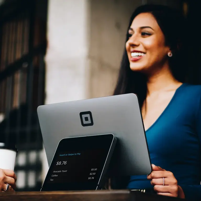 Person smiling over laptop