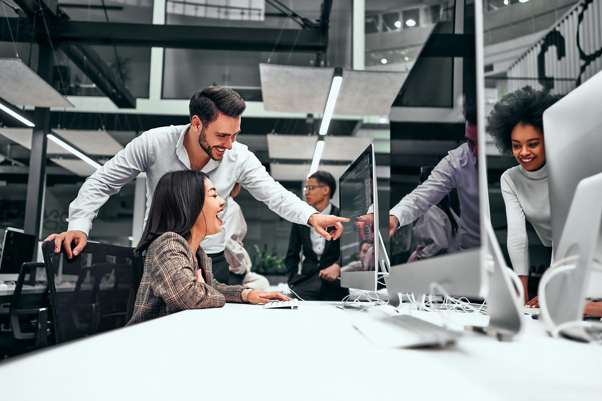 People collaborating at computer screens