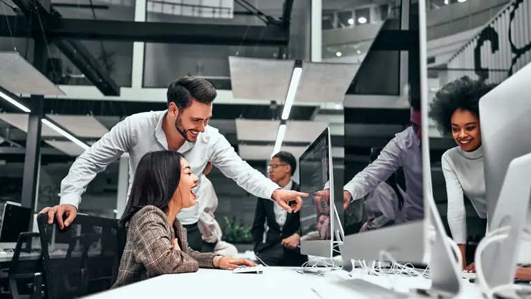 People collaborating at computer screens