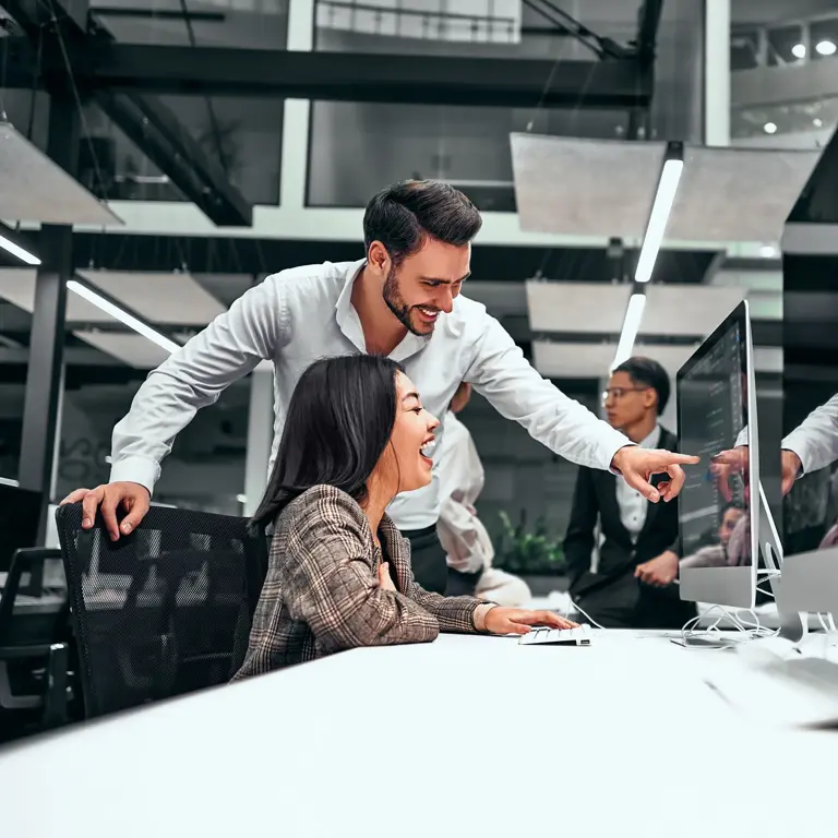 People collaborating at computer screens
