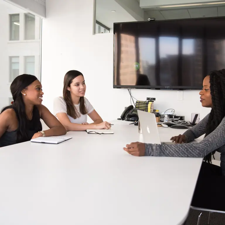 Group of three people in a boardroom