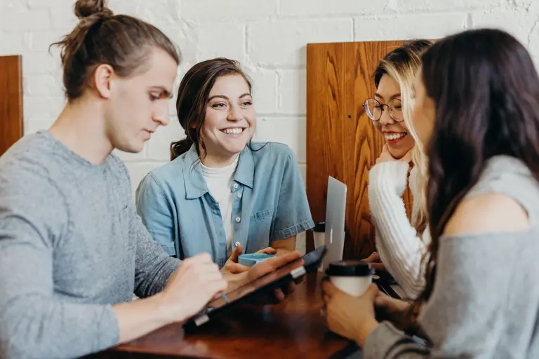 group of four people in a meeting