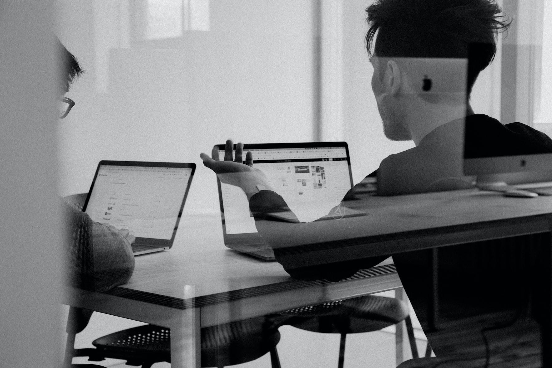 People in meeting behind glass