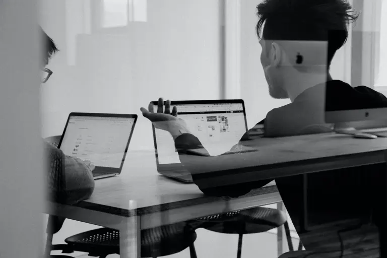 People in meeting behind glass