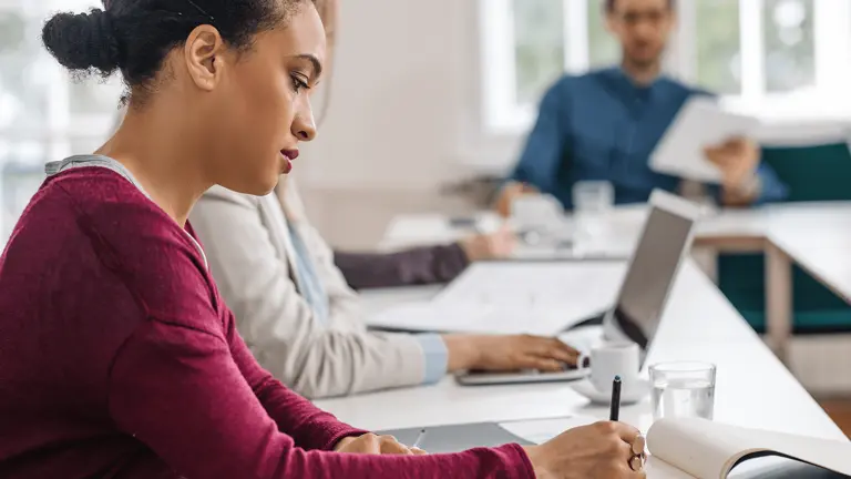row of people working at a desk