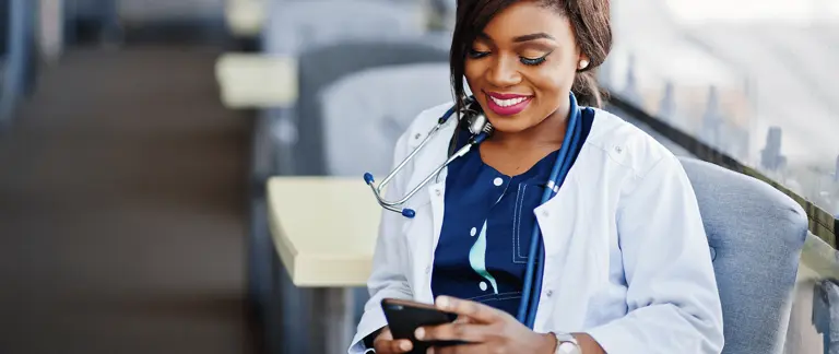 Doctor reviewing best practice information from the Royal College of GPs on a mobile phone