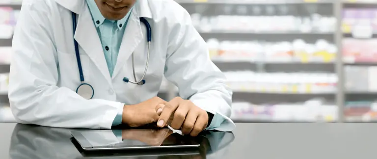 Pharmacist using a tablet to review best practice information