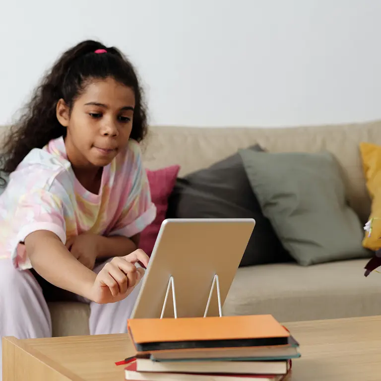 Young girl reading story on tablet device