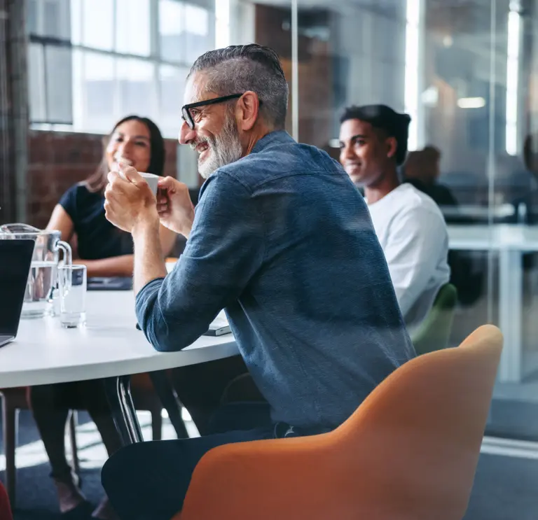 A group of three people in a meeting